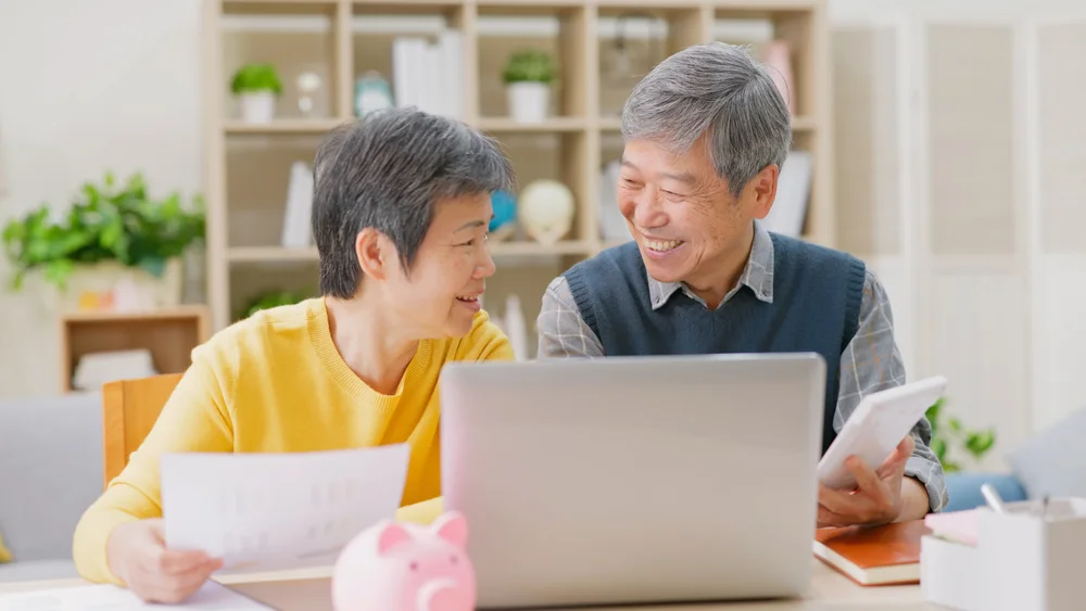 Older couple reviewing paperwork together at home